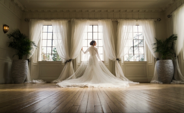Award winning image of bride looking out of window by Jaine BriscoePrice