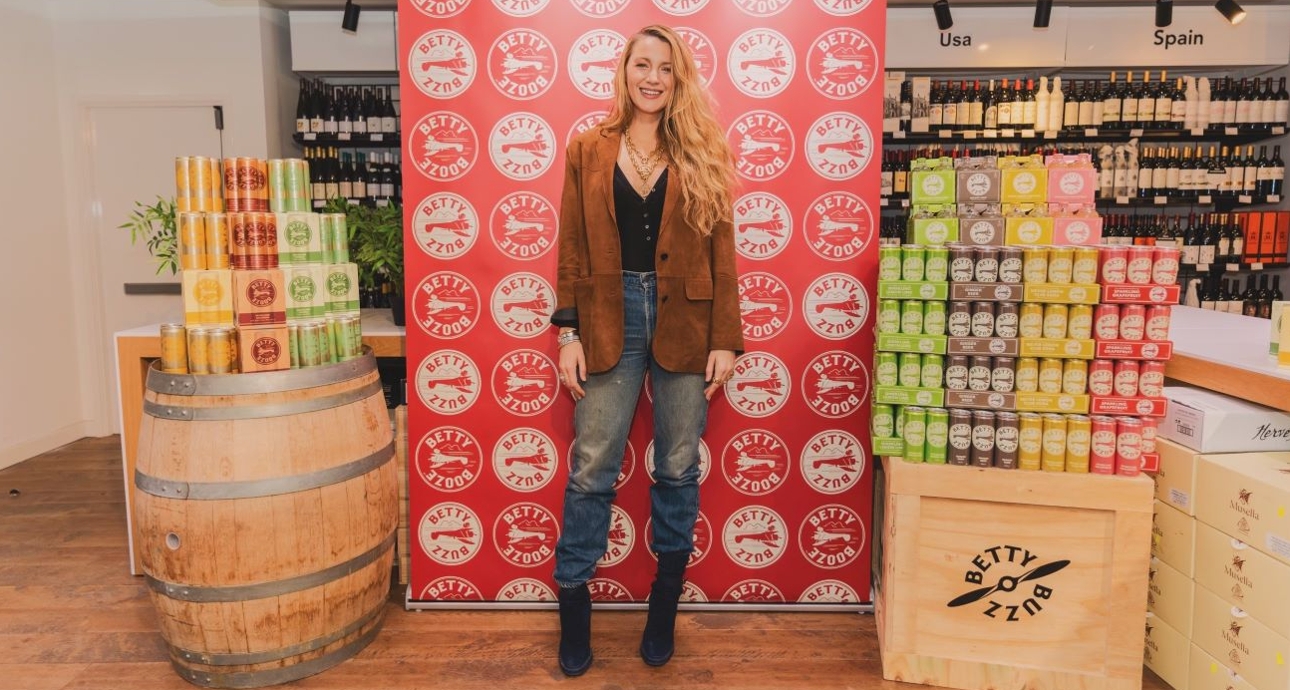 Blake Lively in a Majestic store with display of her drink cans
