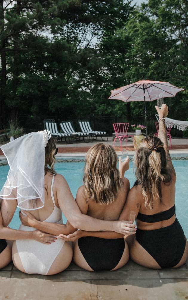 three friend by pool one in veil