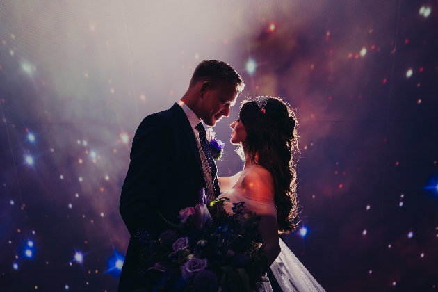 Bride and groom in front of the star projection at Jodrell Bank