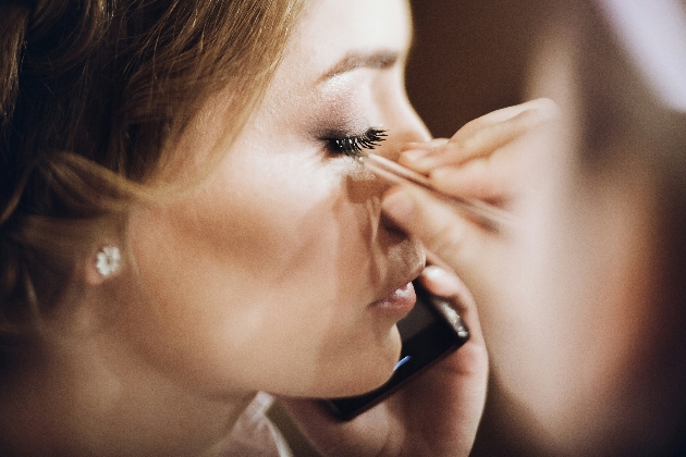 woman applying eyelashes