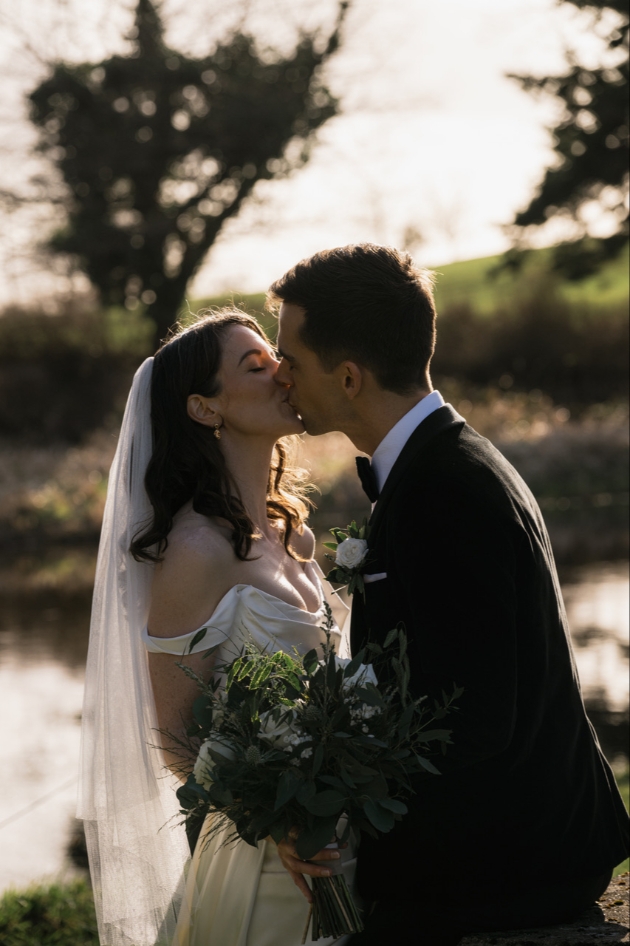 Bride and groom kissing on a dull day