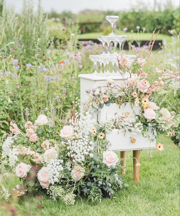 flowers and champagne tower decorating and old upcycled cabinet for a home spun wedding feel