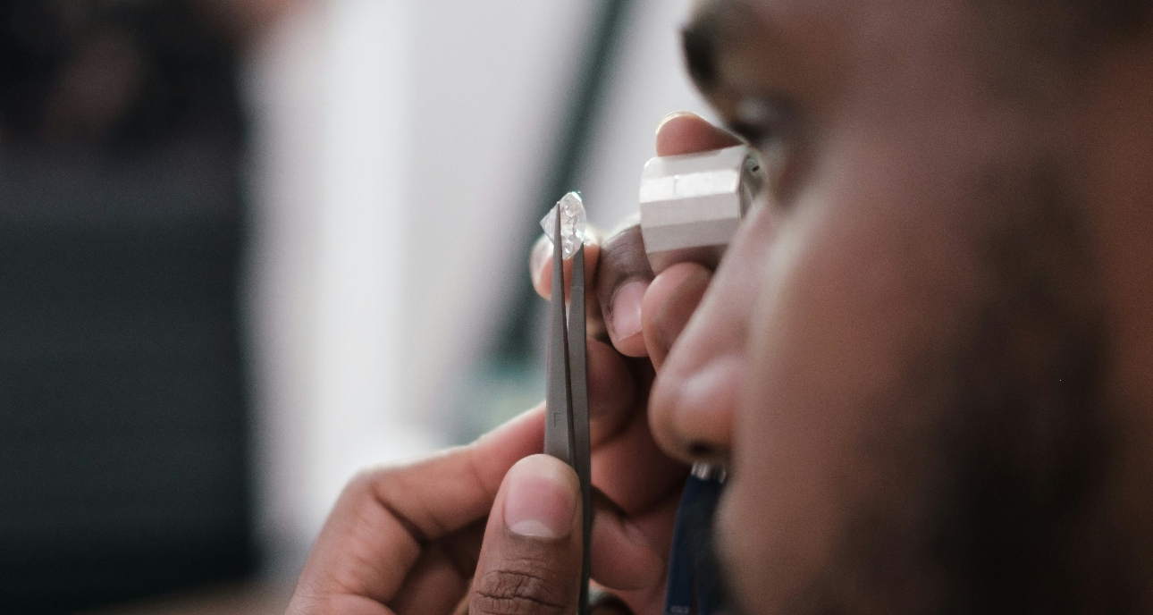 jewellery assessing a diamond with an eye glass