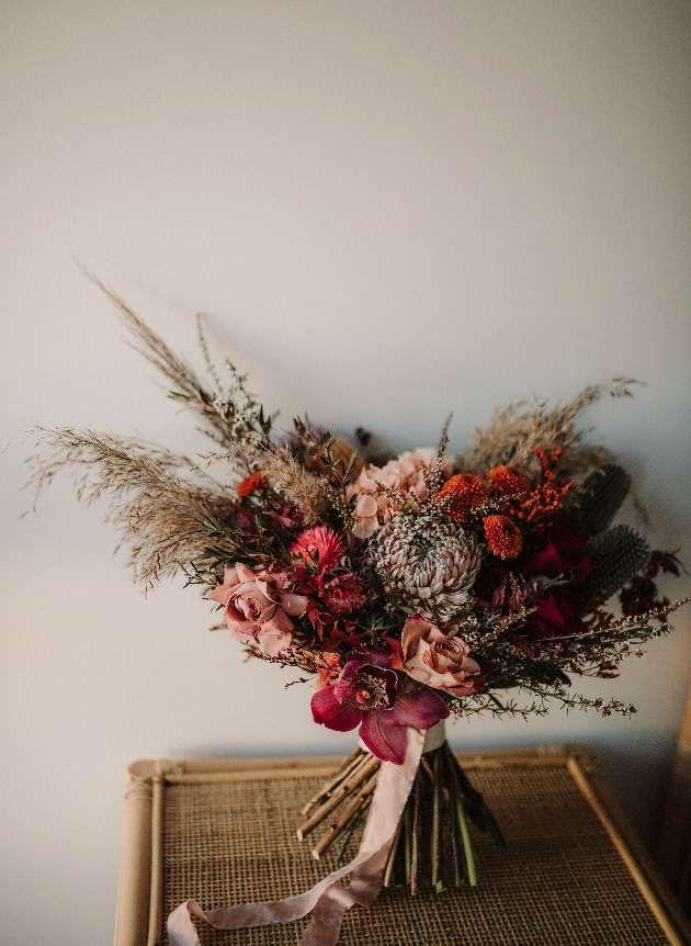 ORCHIDS, STRAWFLOWERS, THISTLE AND WAXFLOWER bouquet