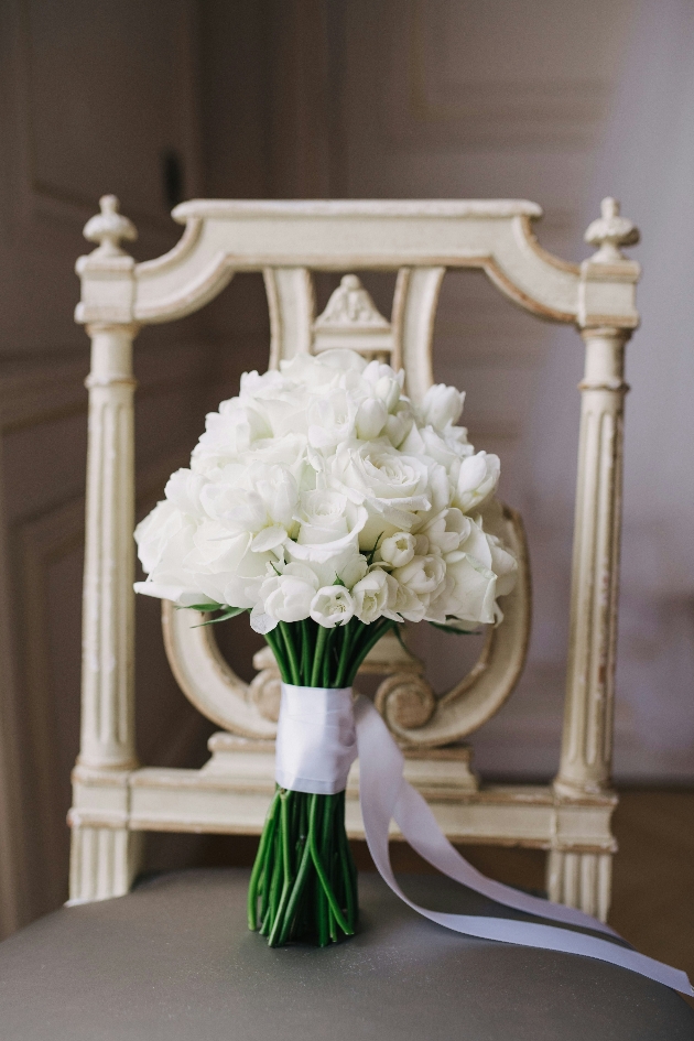 all white bouquet on a chair