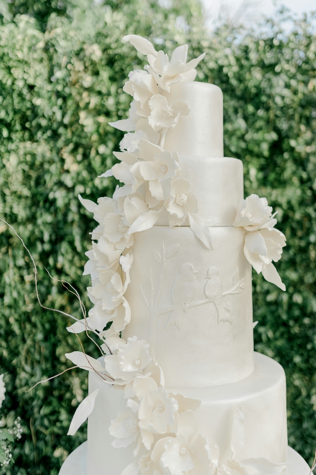 all white wedding cake with sugar flower decoration