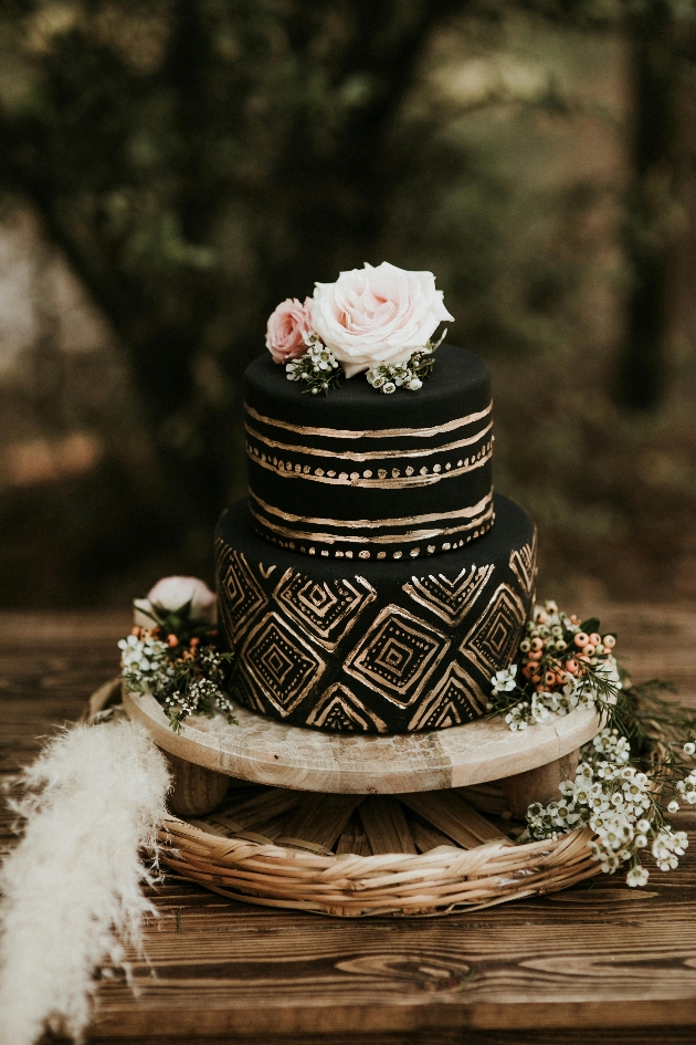 two tier black and gold wedding cake