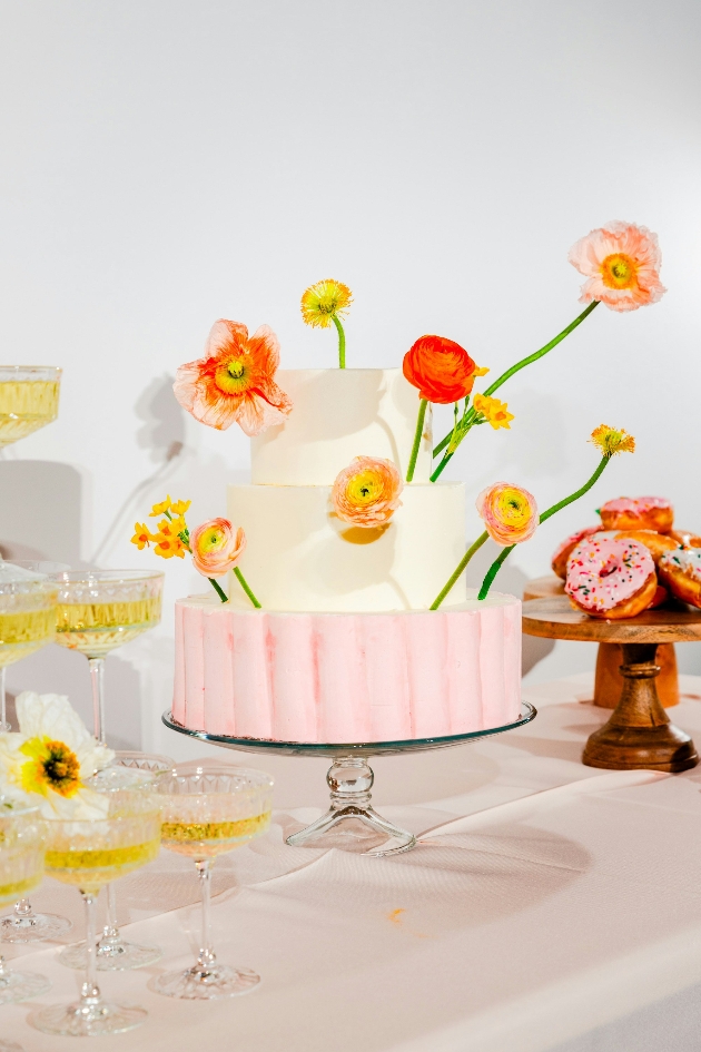 two tier cake decorated with fresh flowers