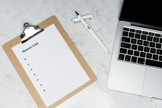 laptop and empty guestlist on a clipboard