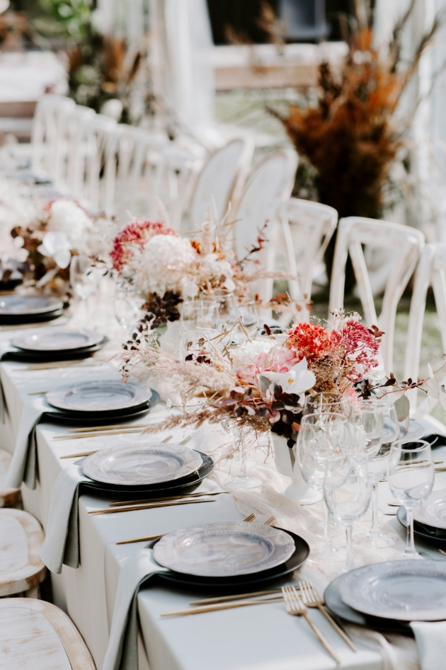 wedding table scape black and white theme with pops of pink in the dried florals