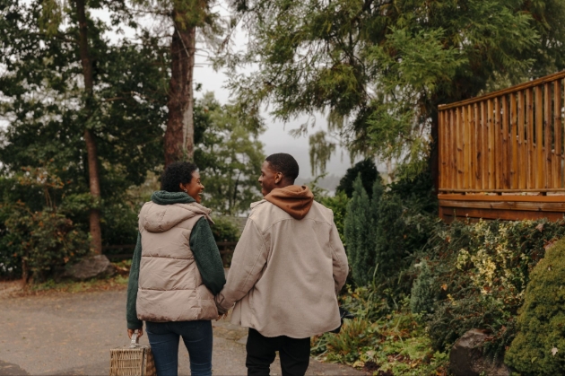 couple walking away through the woods hand in hand