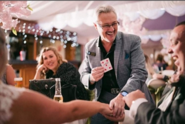 local magician Mike Christy permorming card tricks