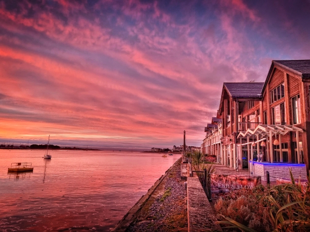 exterior of The Quay Hotel & Spa at sunset